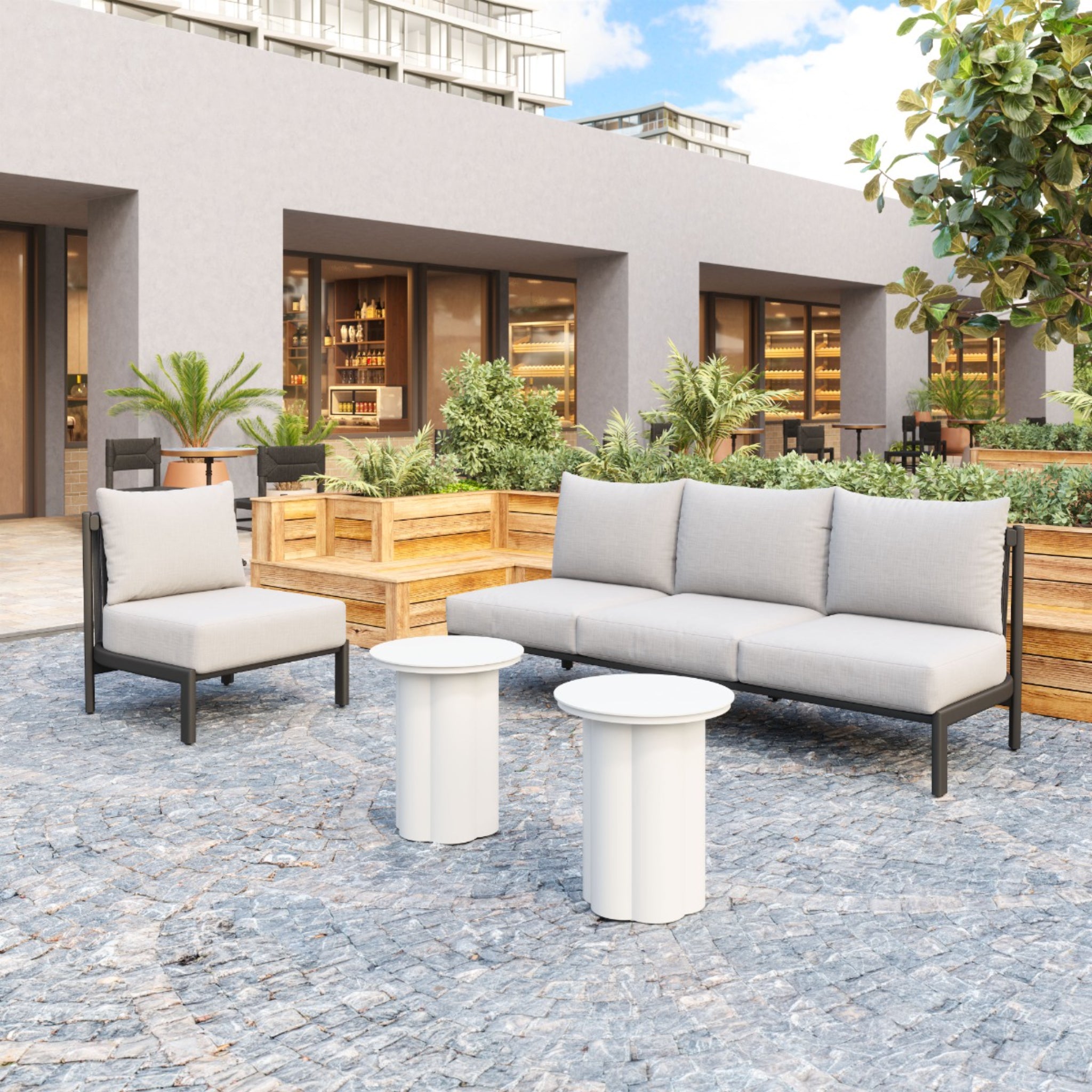 a-product-page-with-a-modern-outdoor-seating-area-featuring-gray-sofa-and-chair-with-white-round-tables-on-a-patio