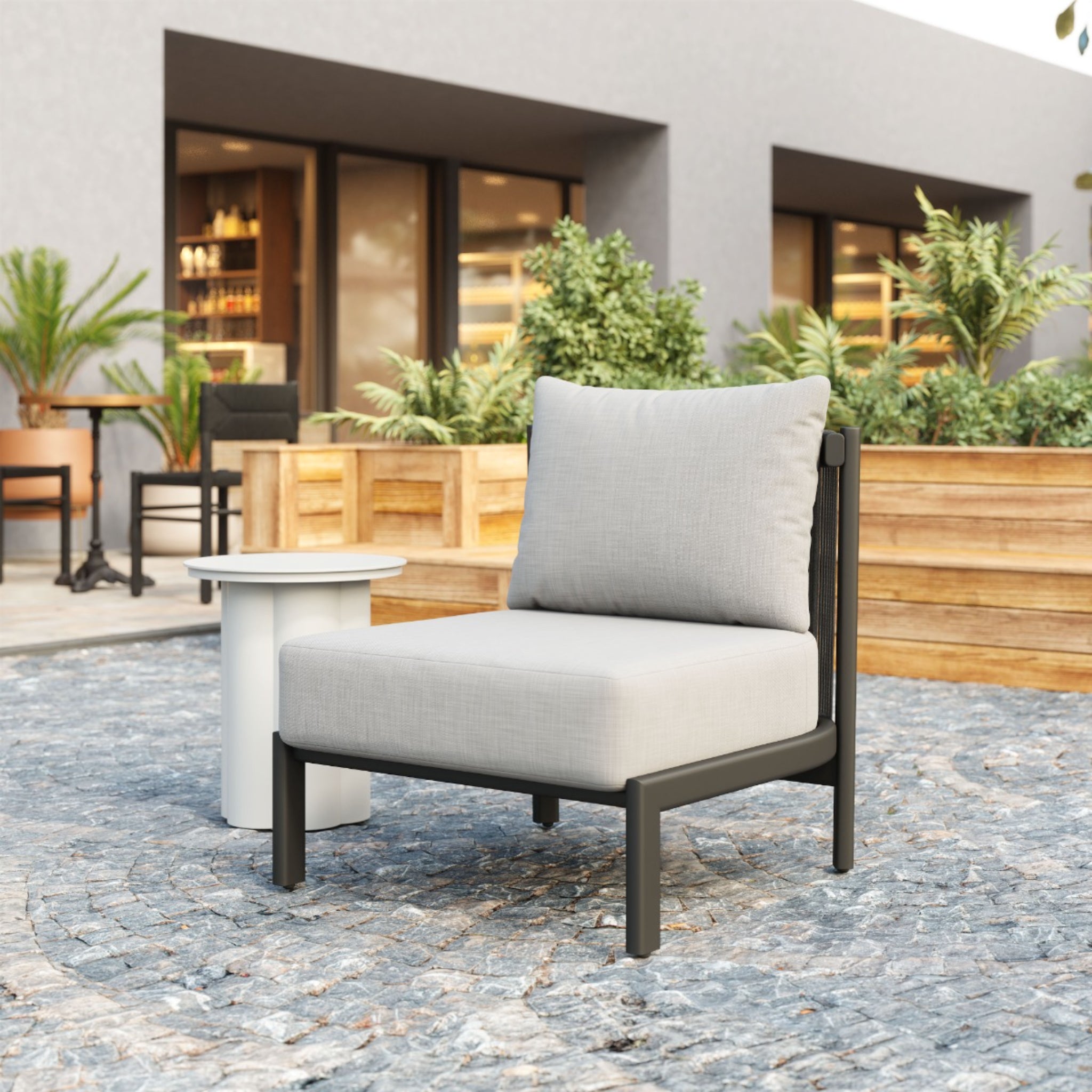 a-product-page-with-an-outdoor-modern-chair-with-gray-cushions-and-black-frame-placed-on-a-patio